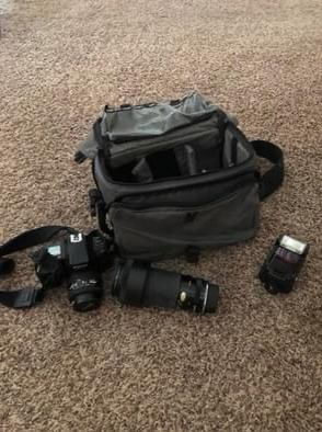 Black slr camera, zoom lens, and bag. 35mm film camera