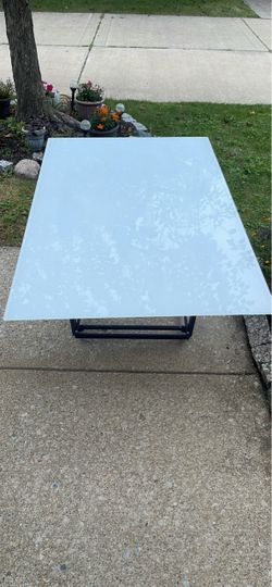 An iron table with a glass top (for the patio, coffee table,