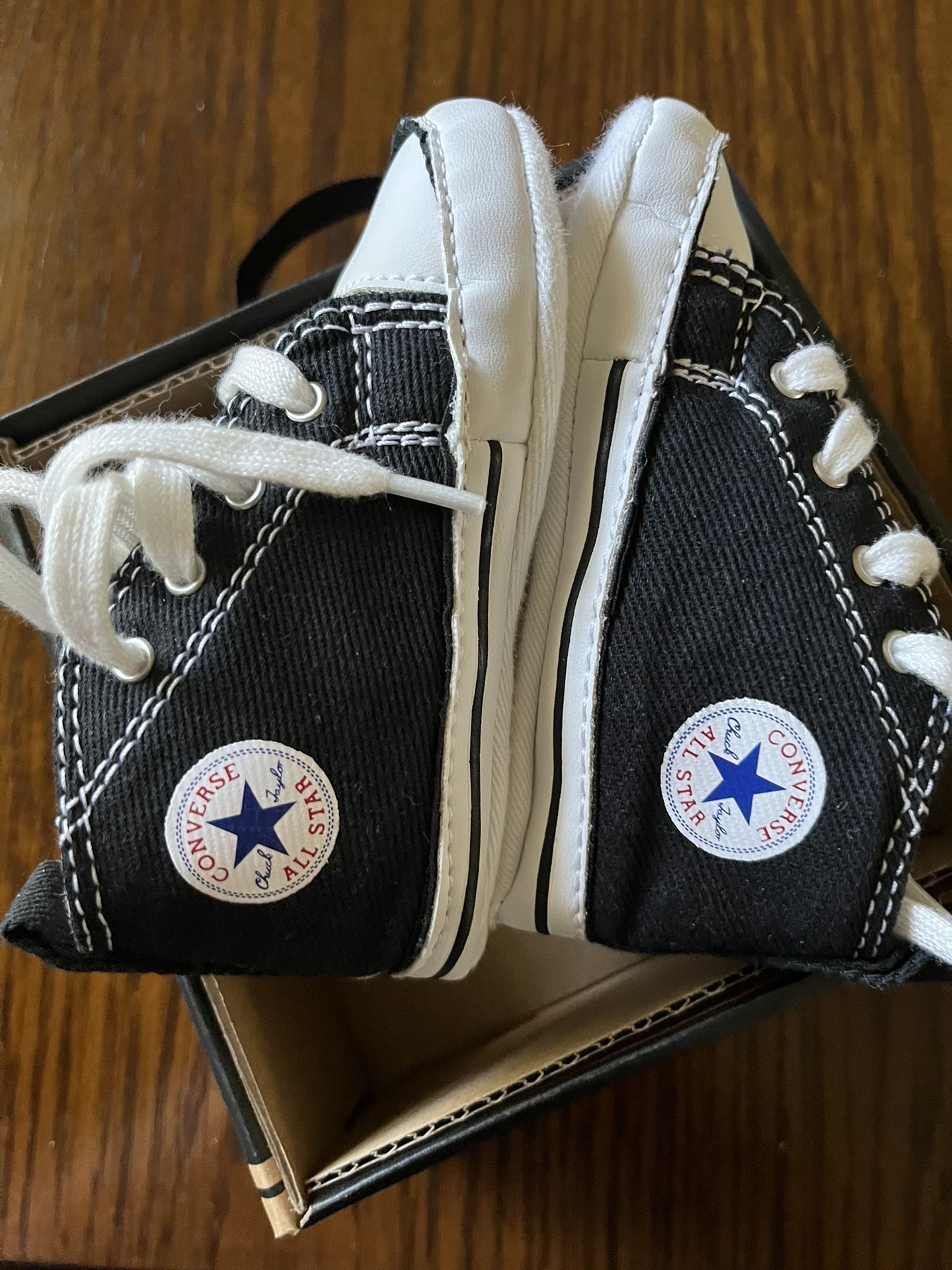 There Very Cute CONVERSE little Shoes For Little Boy. The Size Is 4 The Color Is Black And White Never Been Used