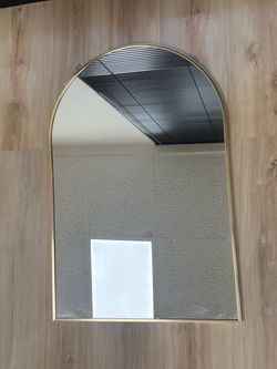 Gold-framed arched mirror