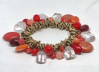 Bracelet with dangling charms in orange, pink, red and white colors and antique bronze