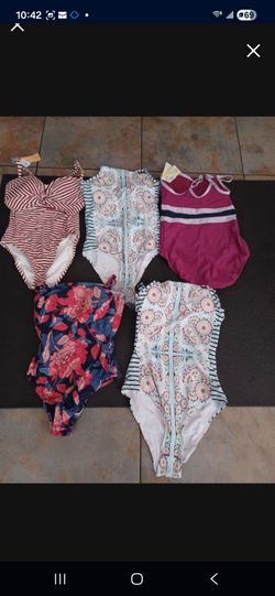 Many bathing suits.  Bikinis with tags all sizes