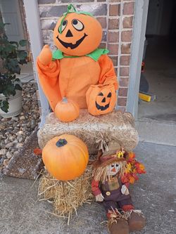 Perfect fall decorations two small hay bales, non scary pumpkin character in great condition, large and small pumpkin and cute scarecrow.