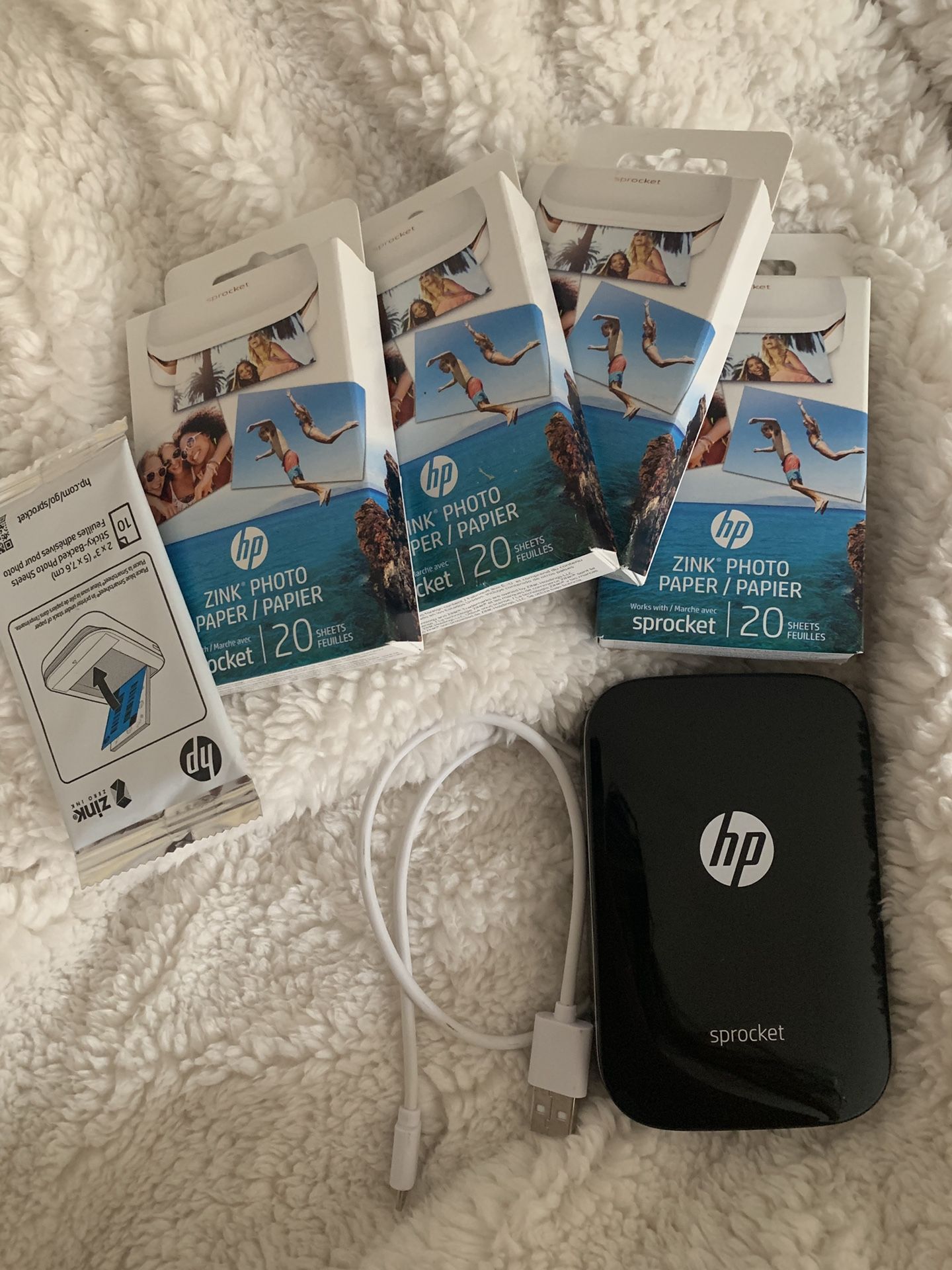 hp sprocket with photo paper. 81 sheets & charger included