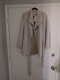 This is a Magaschoni brand beige faux suede wrap trench coat featuring a prominent white label. Medium