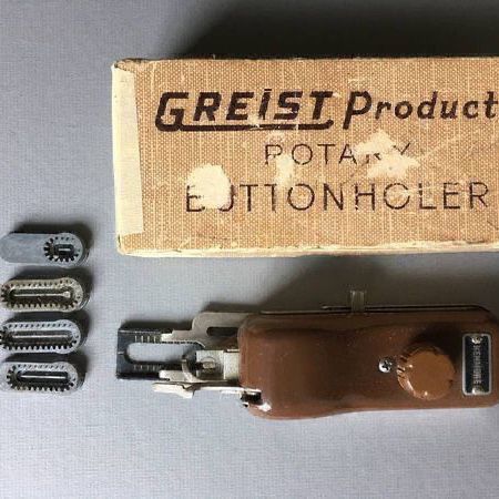 Greist Products Rotary Buttonholer box with a Kenmore branded sewing machine button hole attachment
