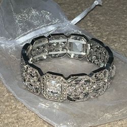 silver bracelet with rhinestone embellishments and ornate detailing