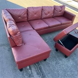 red faux leather sectional + storage ottoman