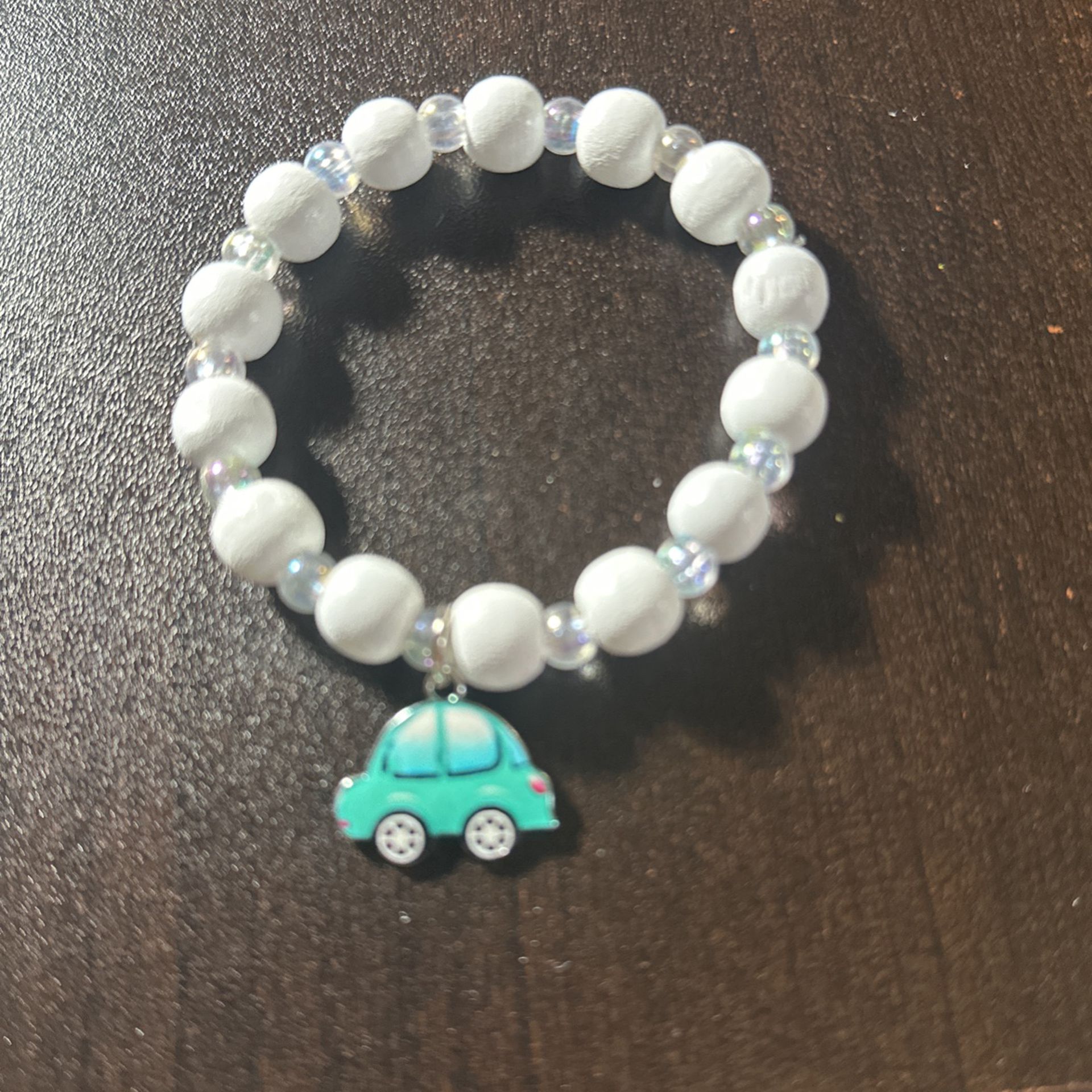 White And Clear Beads Bracelet, With A Blue And White Car Charm