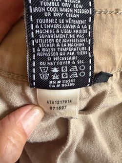 7 For All Mankind Luxe Performance "The Straight" pants featuring a classic   five-pocket design and button fly. Khaki color, size 31, see measurement