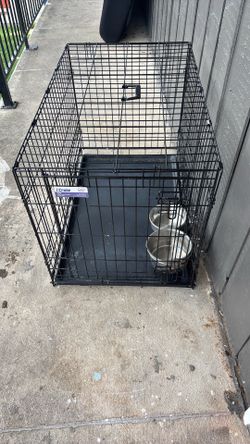Dog cage with bowls mounted