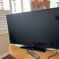 RCA 40” LED LCD Full HDTV TV with Stand, Power Cord, and Remote.