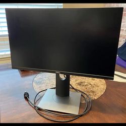 Dell monitor with power cable.