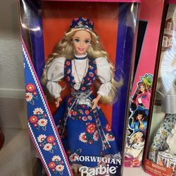 Norwegian Barbie doll from the Collector Edition, part of the "Dolls of the World" collection. The doll wears a traditional, lace-trimmed blue jumper 
