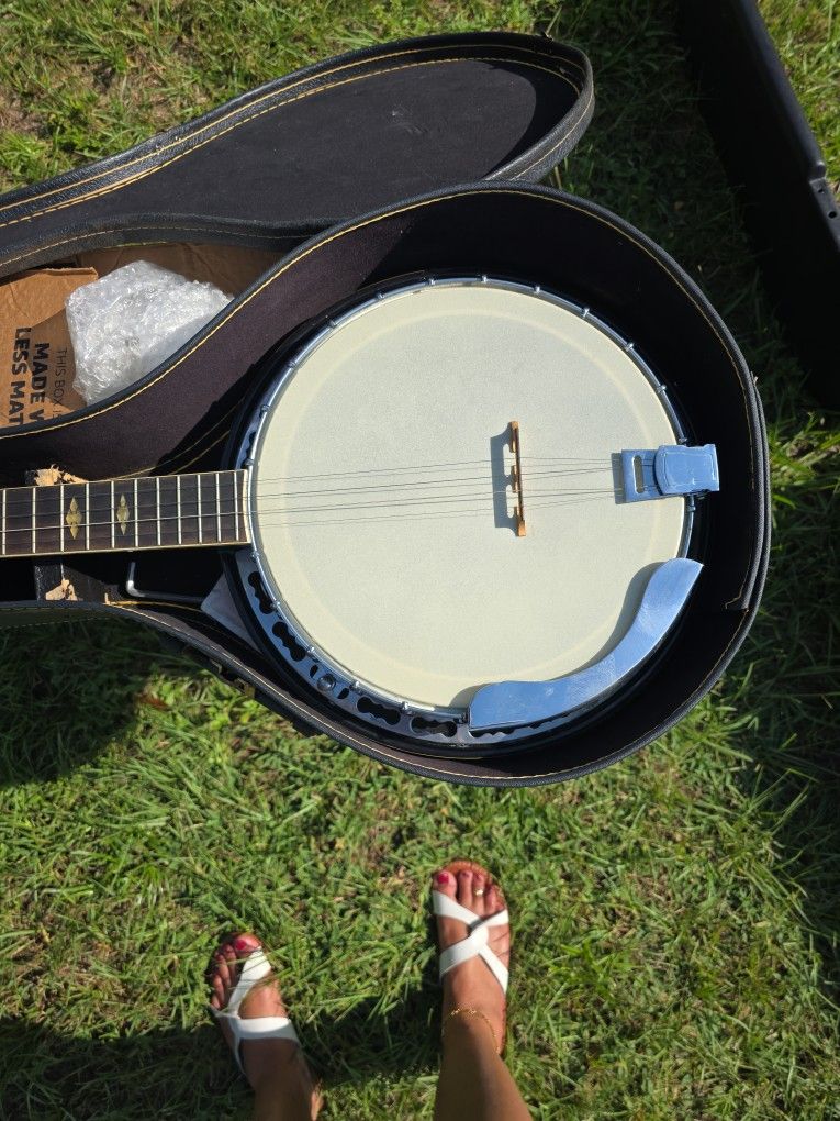 vintage Hohner 5-string banjo with a hardshell case. 