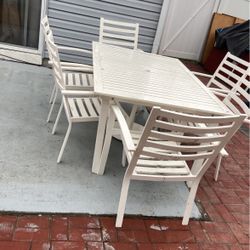 A Nice Outdoor Table With 6 Chairs And Umbrella 
