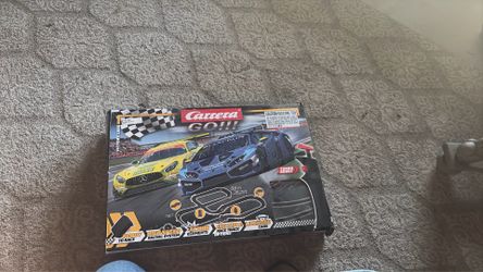 Carrera slot car track and cars.
