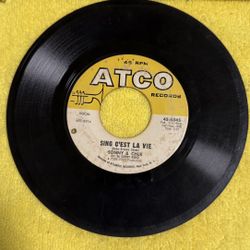 This item is a Sonny & Cher "Just You" / "Sing C'est La Vie" 45 RPM vinyl record, released on the Atco Records label. 