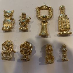 Metal figures gold tone 8 pieces.