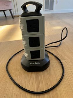 SUPERDANNY Power Strip Tower Surge Protector, which is a vertical multi-outlet charging station designed to save desk or floor space