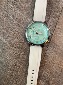 This watch is an AKNIGHT chronograph watch featuring a "Tiffany Blue" textured dial and roman numeral markers.