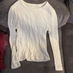 white ribbed or pointelle long-sleeve crewneck top.