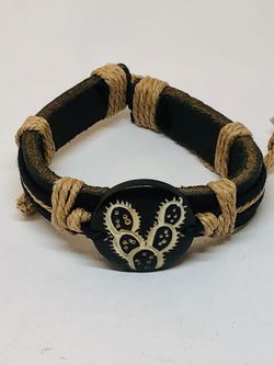 Genuine leather bracelet with center piece made of colored bone with carved cactus