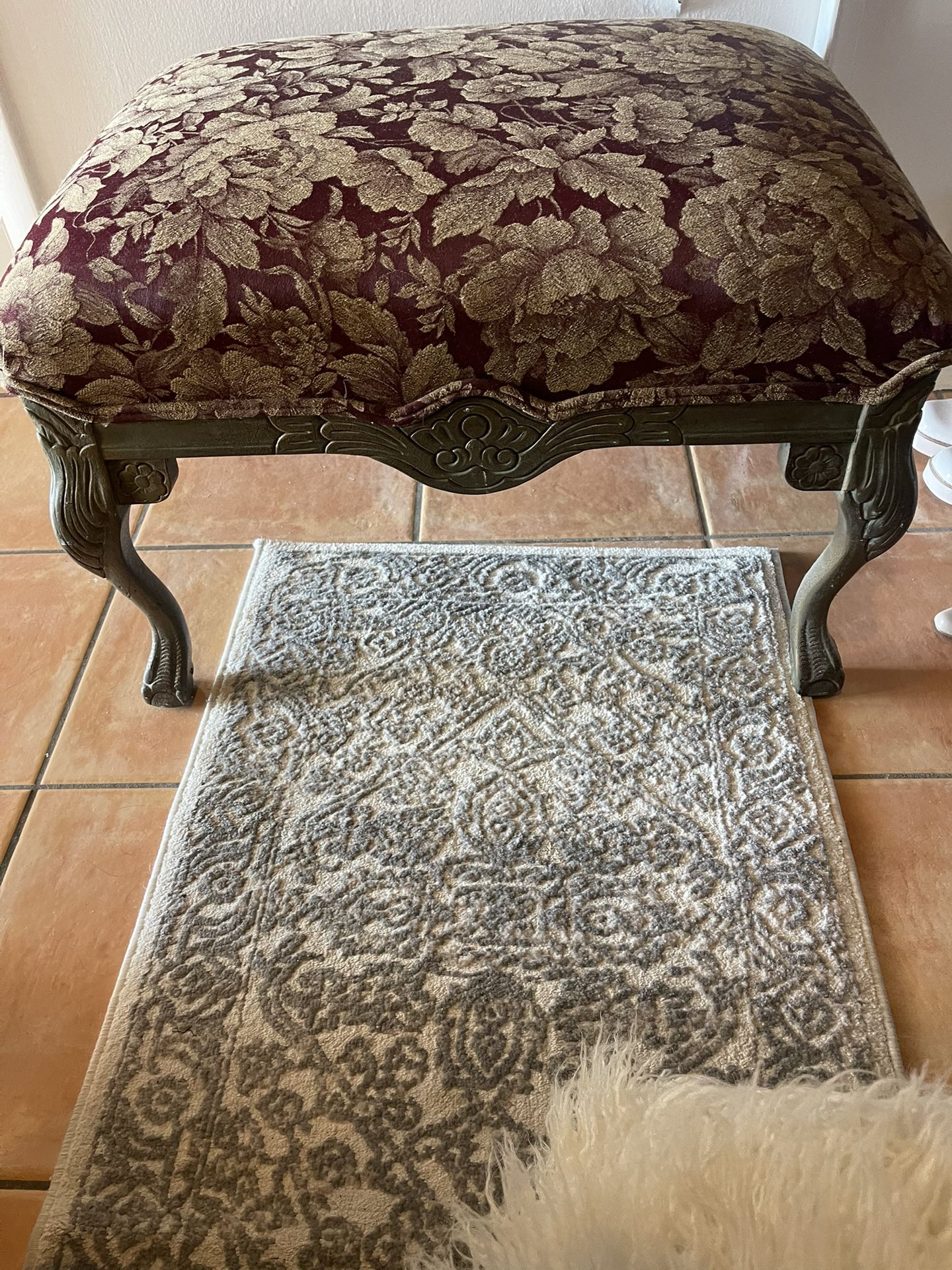 Beautiful French-style bench with carved legs and rich burgundy floral upholstery. Perfect as an entryway seat, bedroom accent, or vanity stool. The c