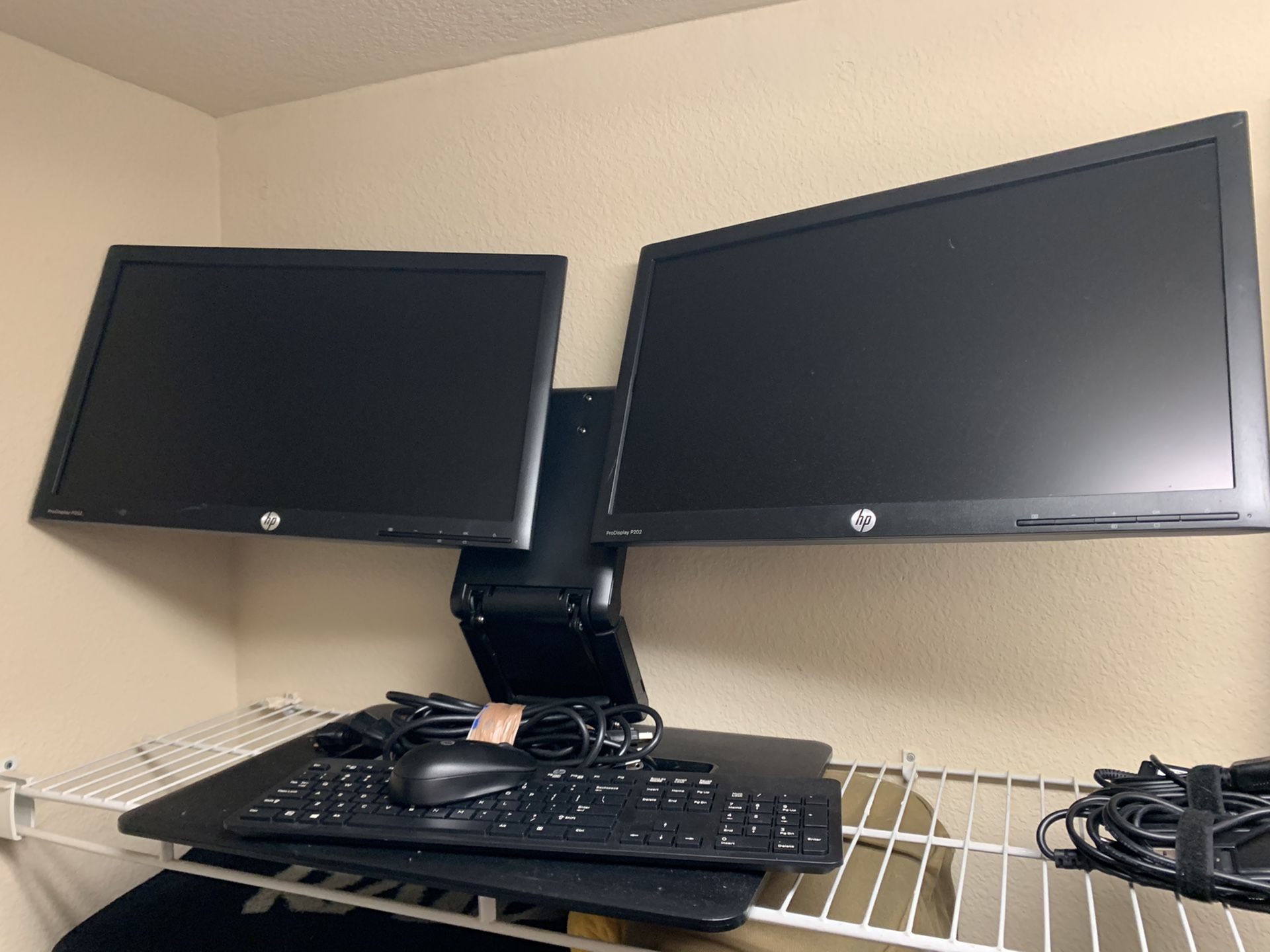 HP double monitors with wireless keyboard and mouse.