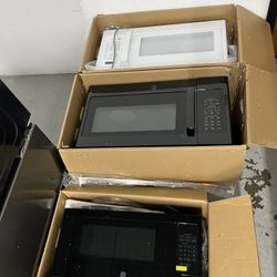 Ge Over The Range Black & White Microwaves —- (1 black countertop)