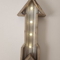 luminous arrow made of wood and metal