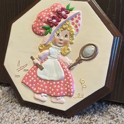 vintage ceramic wall art of a girl in a pink bonnet