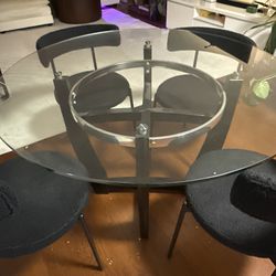 Glass Top Dining Table with 4 Black Upholstered Chairs