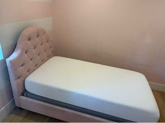 Twin bed with mattress and nightstand