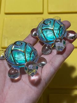 2 glass style turtle figurines