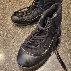 Youth  size 1 (adult sizing) And1 black tennis shoes, small rip near top of toe