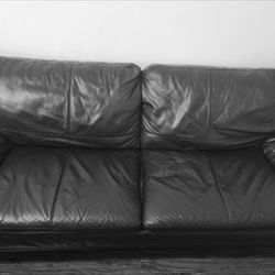 Black Couch And White Chair And Heavy Coffee Table