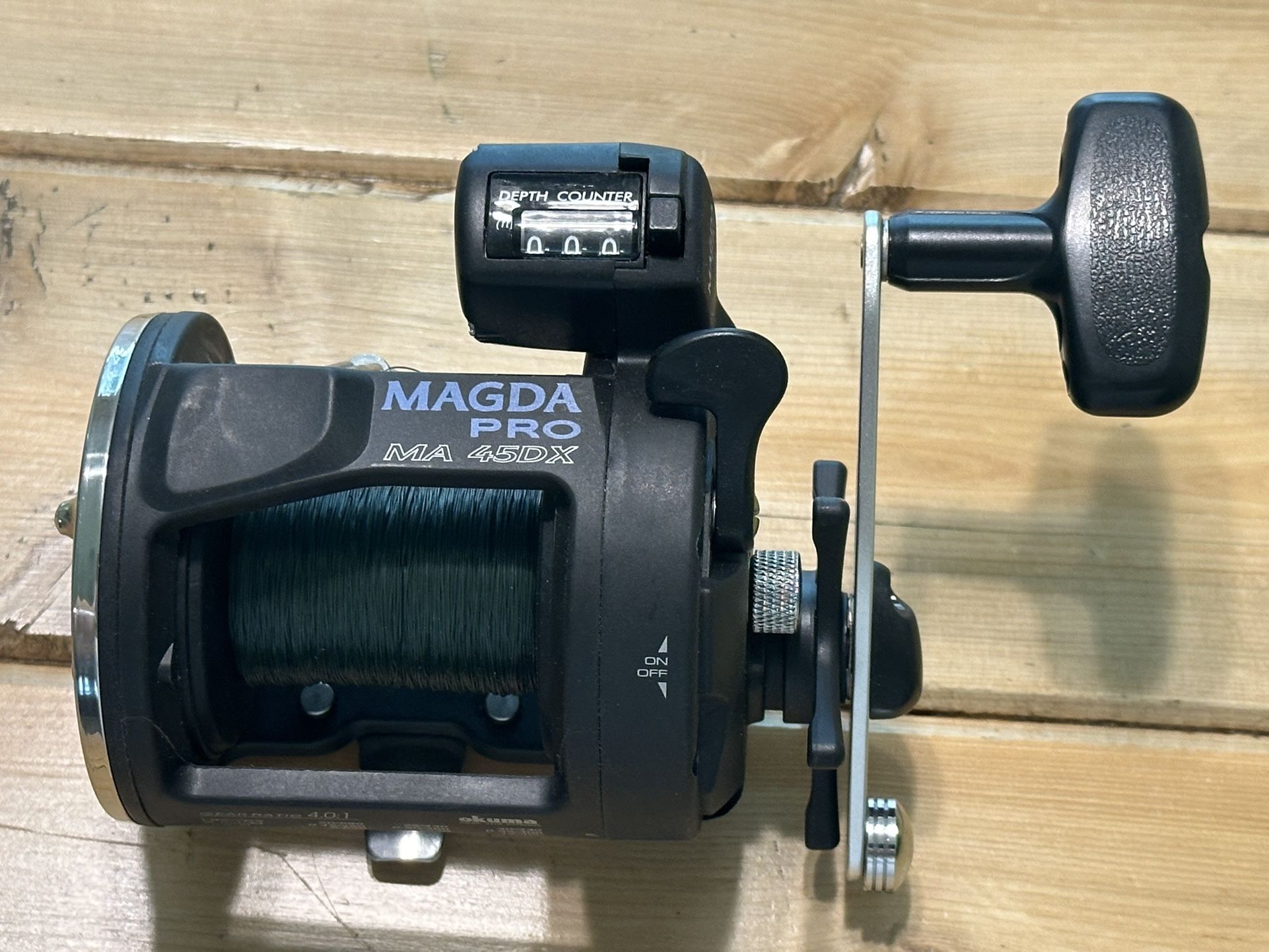 * BRAND NEW - Never Used * Okuma Magda Pro Line Counter Trolling Reel With Auto Trip MA 45DX * 300 yards of 30lbs Green Mono Trilene Line Newly Spool