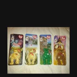 Set of 4 TY Beanie Babies Glory,  Erin,  Britannia, And  Maple the Bear McDonalds 1999. New, unopened, plastic packing is yellowed.