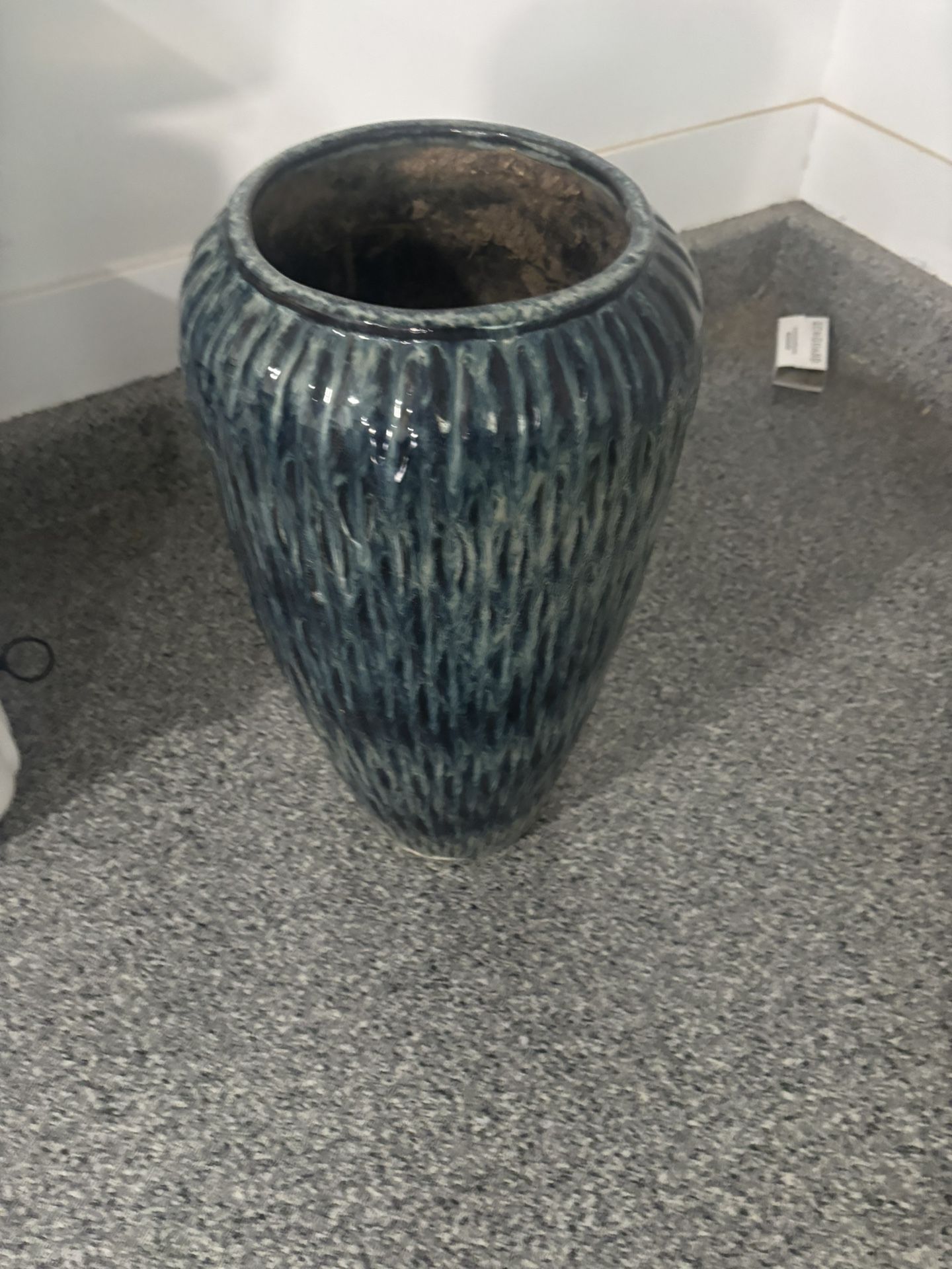 This is a tall, round, teal ceramic planter with a textured, ribbed finish.