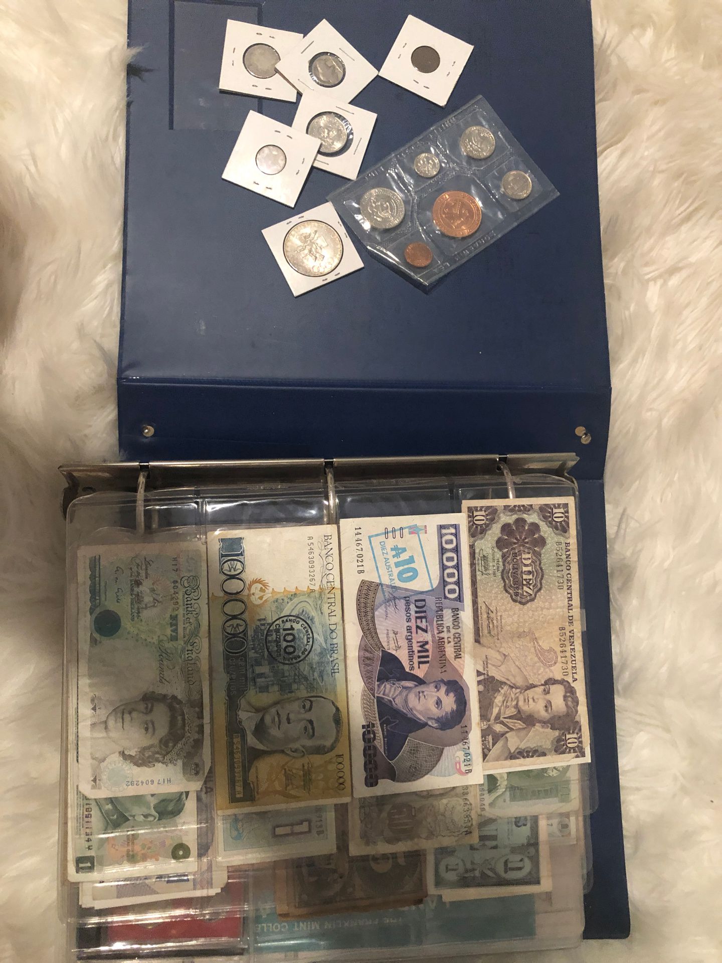 Binder of collectible real coins and bills from all over the world