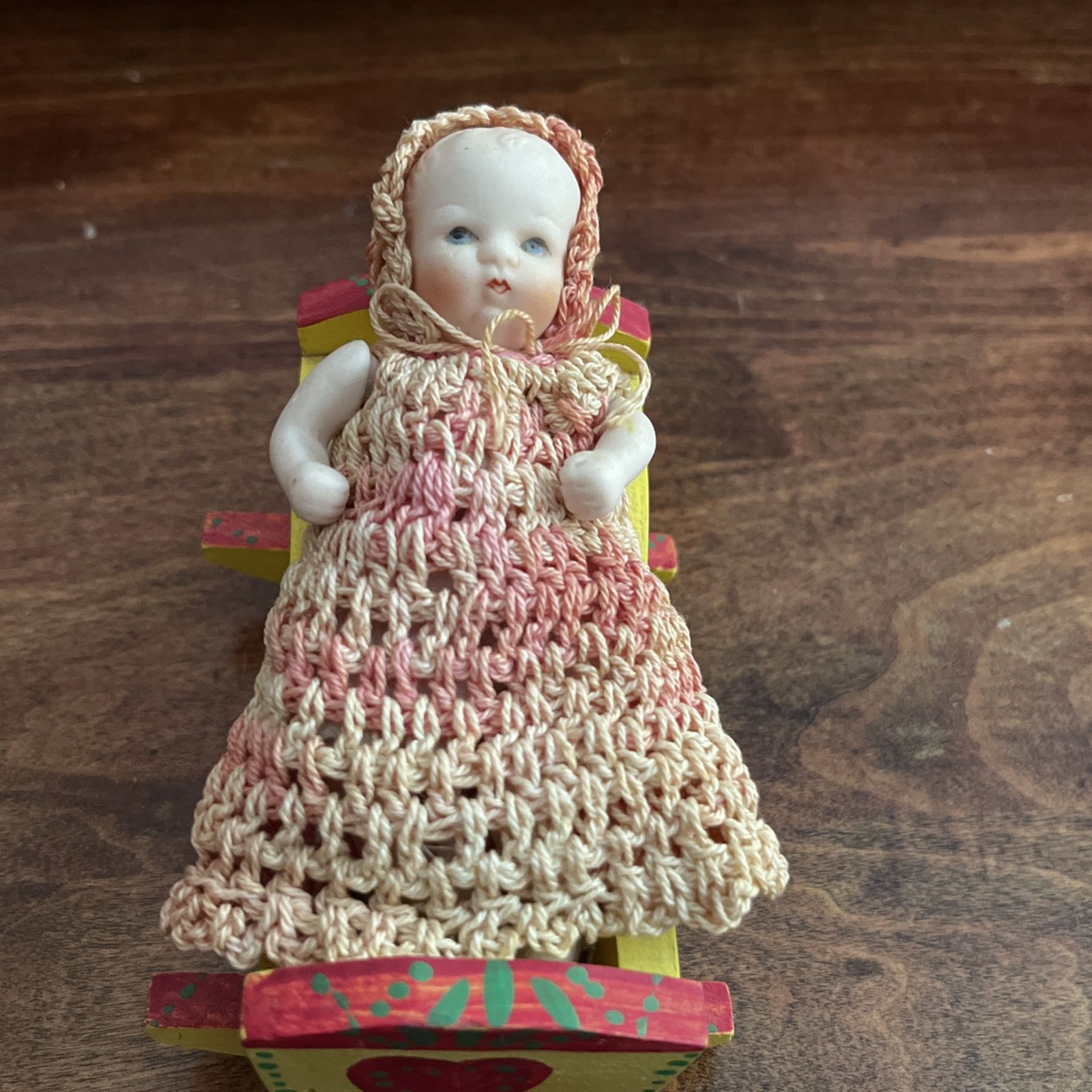 Antique Doll In A Rocker Bed