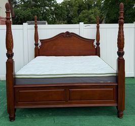 Beautiful colonial-style King bed has carved poles and decorative finishes, possibly mahogany or similar wood with mattress and Boxspring included can