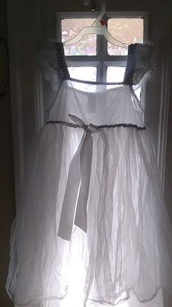 Size 8-10 x 100% polyester white sheer dress with sparkly top.