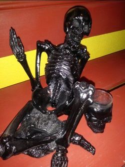 Skeleton bottle holder with shot glasses to match