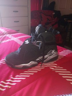 All black Jordan 8s size 6y grey and white at the bottoms