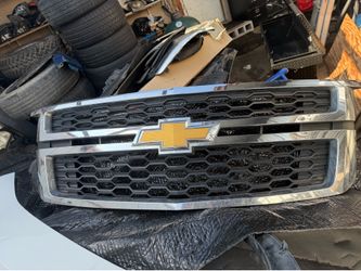 Chrome and black honeycomb front grille assembly for a 2015-2020 Chevrolet Tahoe, Suburban, or Silverado 1500.
