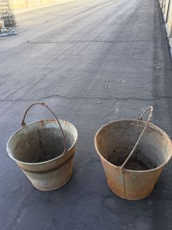 Two vintage metal buckets as planters