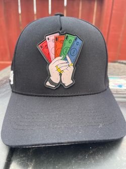 JC Hats "Never Look Back" snapback cap featuring a Monopoly-themed cash graphic patch.