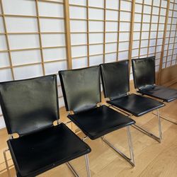 Black Italian leather modern dining chairs (price includes the entire set of four)